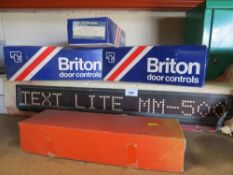 A boxed Text Lite illuminated sign and four unused overhead door closures