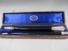 A cased two piece hallmarked silver mounted conductors baton engraving from 1902