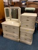 Three modern cream chests with a triple mirror