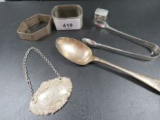 Six pieces of silver two napkin rings and a whisky label