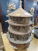 An unusual Oriental ceramic table lamp in the form of a temple with a fived toed dragon flying