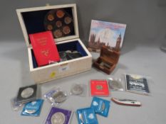 A box of collectables to include vintage British coinage, dog tags etc