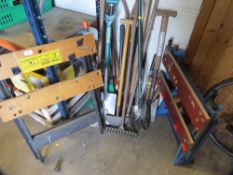 A quantity of assorted garden tools plus a work bench