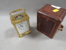 A carriage clock with travelling case
