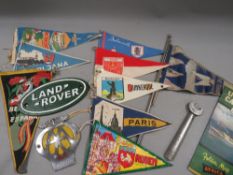 A collection of vintage pennants, car mascot flag, AA car badge etc.