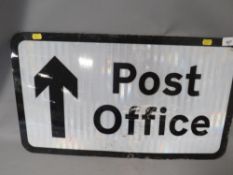 A metal backed post office sign