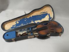 An old violin missing strings etc