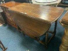 An oak barley twist drop leaf table
