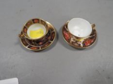 Two Royal Crown Derby miniature cups and saucers both with early 20th century cypher marks