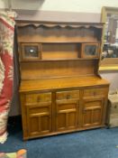 An oak linen fold glazed dresser