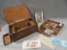 A small quantity of collectables in a wooden box, coins notes and lighters