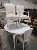 A French style circular dining table and four chairs