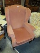 A soft velvet wing backed armchair