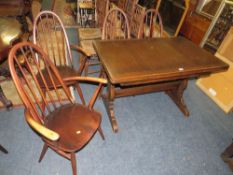 An Ercol dining set comprising an extending table and four chairs