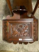 A vintage carved mahogany wall corner cupboard