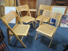 A set of four wooden fold-up chairs