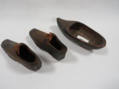 A pair of antique child's hob nail shoes together with a tray of assorted ceramics and glass