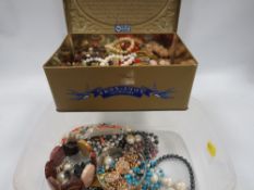 A tub of assorted vintage costume jewellery to include necklaces