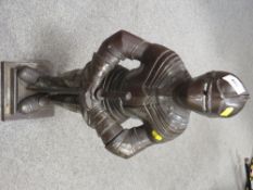 A novelty cast metal companion set in the form of a knight in a suit of armour