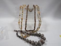 A collection of aggate, polished stone necklaces etc