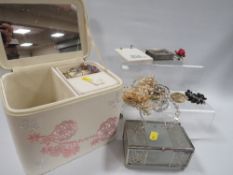 A jewellery box with costume jewellery contents