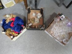 Three trays of sundries to include eastern puppets, glassware etc
