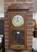 A vintage oak cased clock with key and pendulum