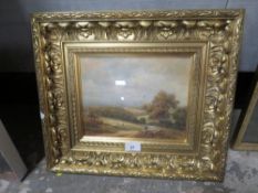 A gilt framed and glazed oil on board of a Shepherd resting with his flock, indistinctly signed
