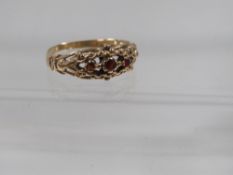 A hallmarked 9 carat gold three stone garnet ring approx. weight 1.4g ring size N