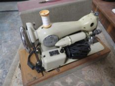 A vintage cased Cresta electric sewing machine
