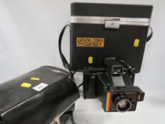 A vintage cased polaroid land camera super colour swinger III together with a vintage cased video