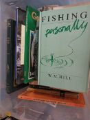 A tray of vintage fishing books