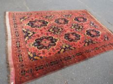 A large pale red Persian style rug - approx. 290 x 198 cm