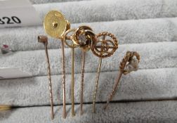 A collection of six gold stick pins to include an 18 carat gold example