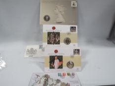 Two five pound coins in stamp covers along with other commemorative covers and coins