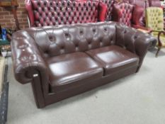 A brown chesterfield style sofa bed