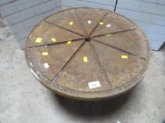 An antique cast iron cheese table