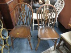 A pair of oak wheel backed chairs together with a pair of painted wheelback chairs (4)
