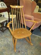 An Ercol blonde oak rocking chair