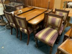 An Edwardian mahogany wind-out dining table with two additional leaves and a set of six chairs -