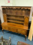 An antique oak and mahogany crossbanded Welsh dresser with three drawers, raised on cabriole legs