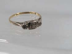 An unmarked yellow metal three stone diamond ring approx. weight 1.6g ring size M