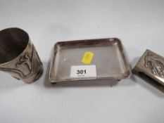 A continental white metal cup decorated with a three toed dragon with character marks to base