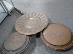 An eastern style copper charger together with two copper warming pans