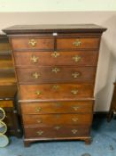 An antique oak tall boy with two short over three long drawers and three further long drawers to the