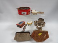 A set of four hallmarked silver napkin rings approx. combined weight 60.6g together with a small tin