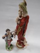 An 1800's type Royal Crown Derby figure of a man playing the flute together with a religious