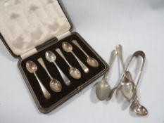 A cased set of silver hallmarked tea spoons together with another selection of spoons