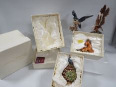 Four boxed hidden treasures boxes to include an eagle, falcon, peacock on an egg and a horse