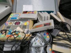 A cased Nintendo super NES console game and controllers (unchecked)